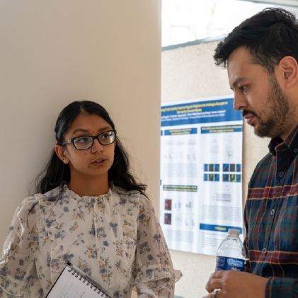 Second year MCP student, Charukesi Sivakumar (Rao Lab) discusses 'Elucidating the Role of KAT8/MOF in Retinal Development and Disease' with one of the >160 symposium attendees during the poster session at the 22nd Annual MCP Research Symposium (November 2023).