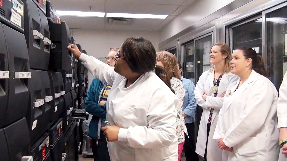 Med tech, Michele McGee shows nursing staff the incubators in Microbiology.