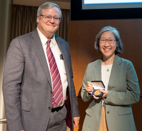 Dr. Charles Parkos presents Henry Clay Bryant Professorship Medallion to Dr. Annette Kim.